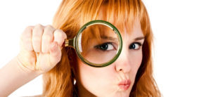 Crop image of woman using magnifying glass