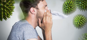 Man sneezing with viruses coming out