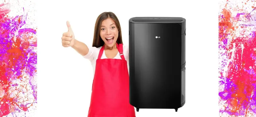 Woman in red apron having a thumbs up sign with dehumidifier beside her
