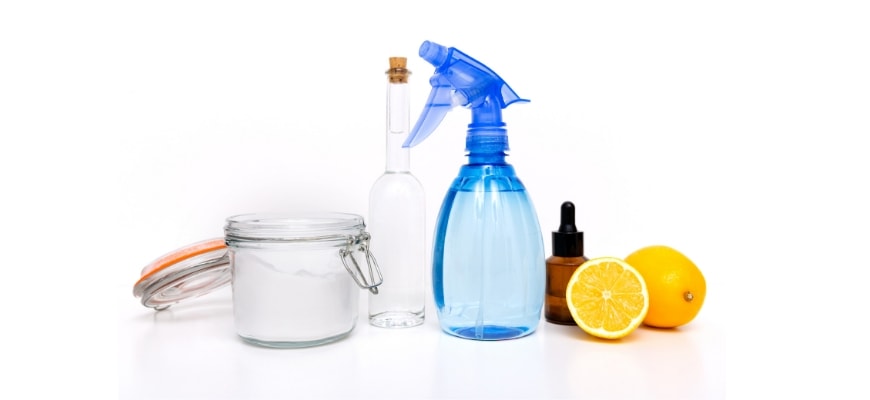 Salt, spray bottle, lemon, essential oil bottle in white background