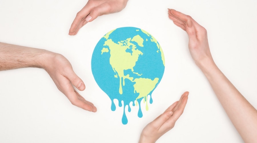 People's hands circling the globe in white background