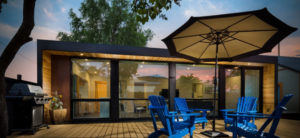 Beautiful Eco-Friendly House with blue chairs and umbrella outside