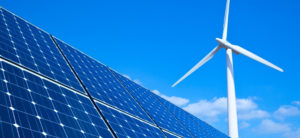 Wind turbine with solar panel in blue sky background