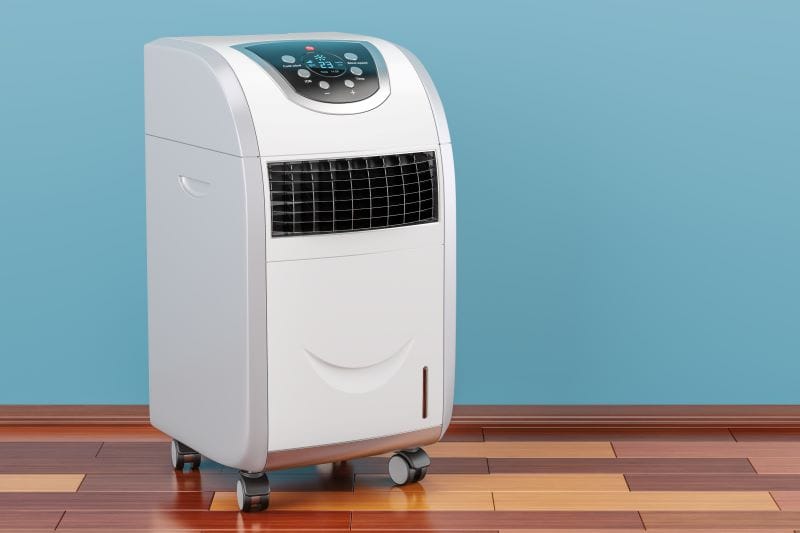Haier 14000 13,500 BTU 115V Dual-Hose Portable inside the room with blue wall and brown tiles floor